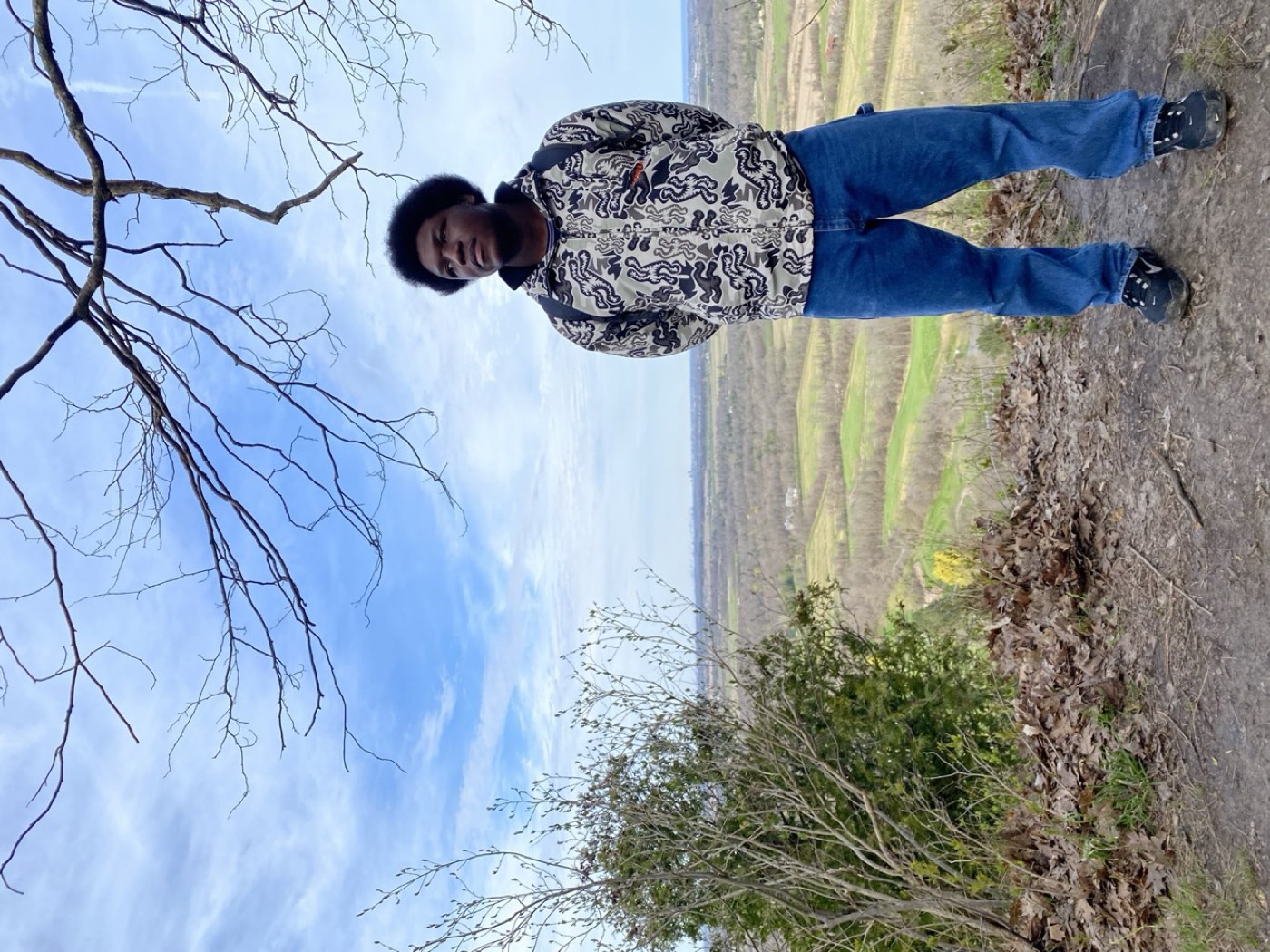 David at a lookout above a wide green valley